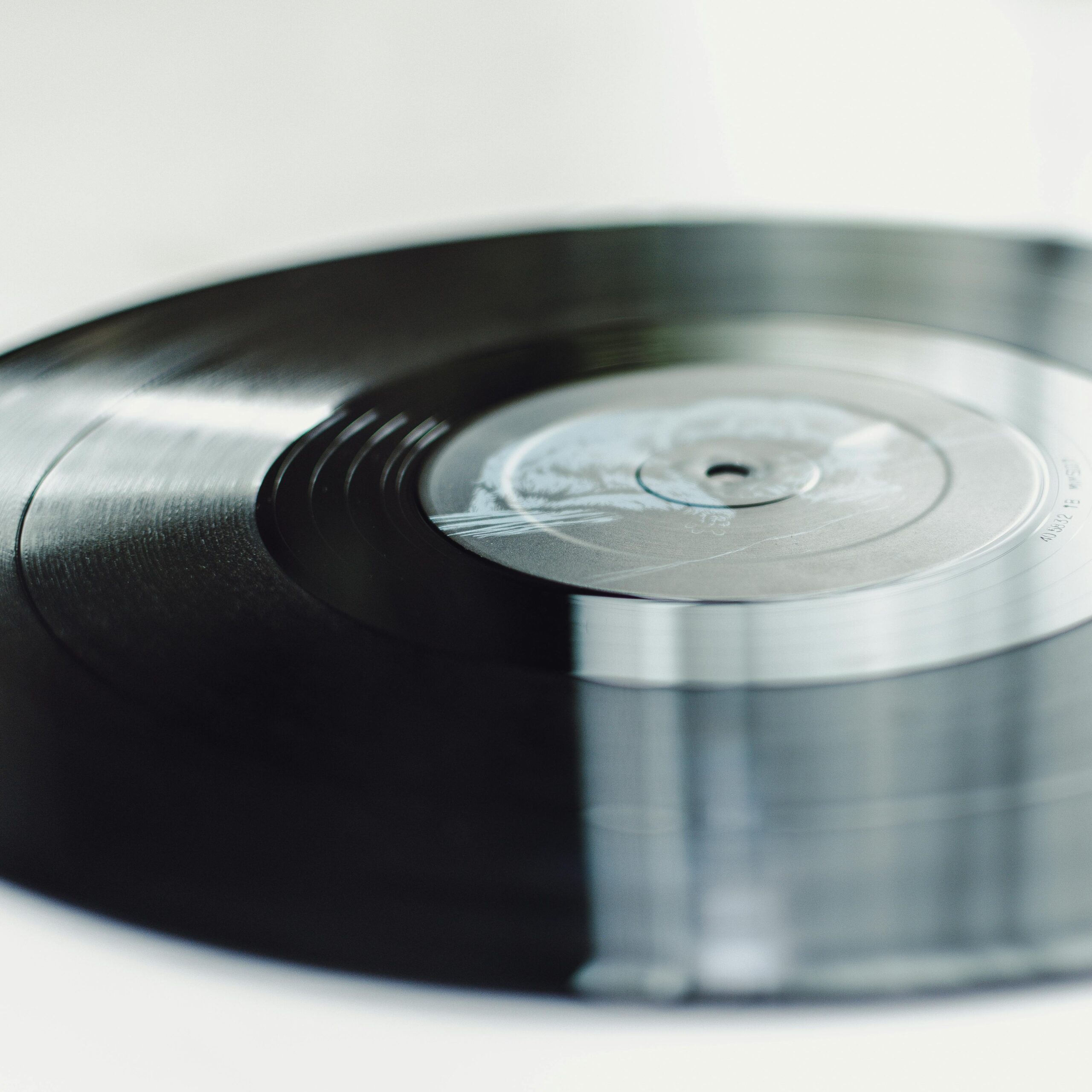 Close-up of a spinning vinyl record on a turntable, capturing the nostalgic essence of analog music.